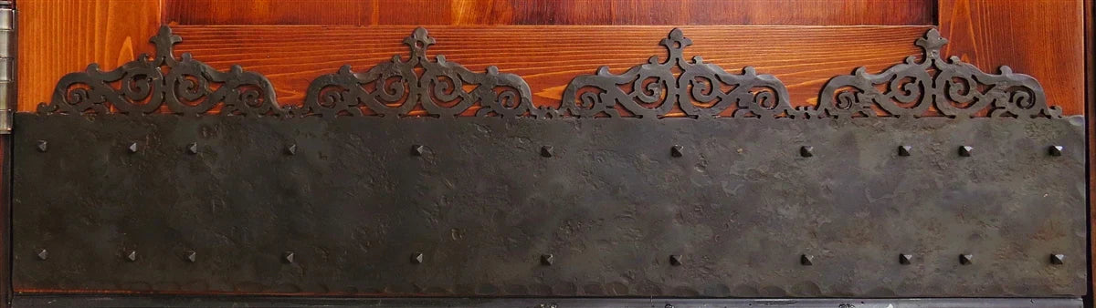 Decorative metal kick plate with intricate design and sturdy construction for doors