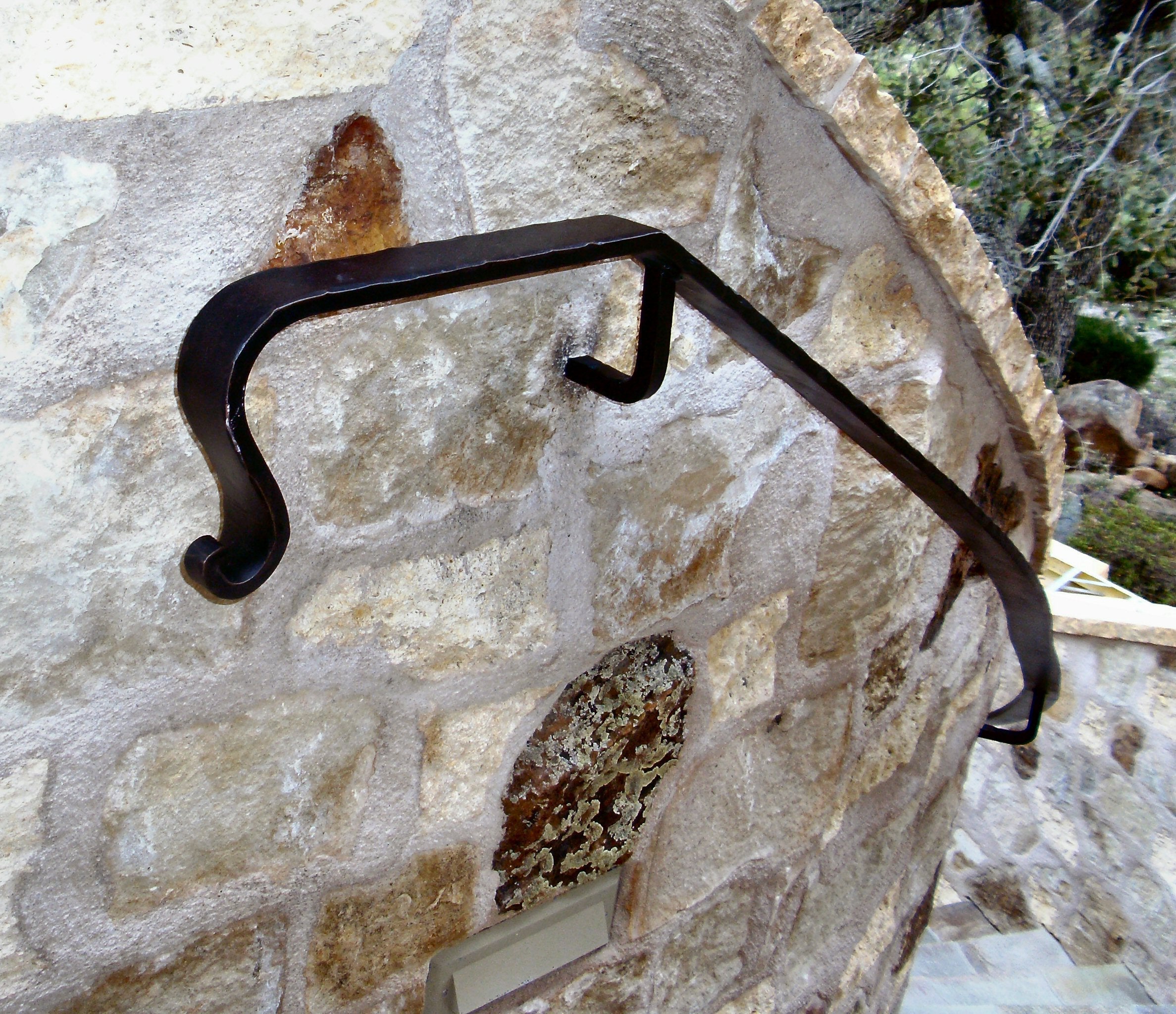 Elegant handrail bracket on a stone wall, combining safety and rustic design