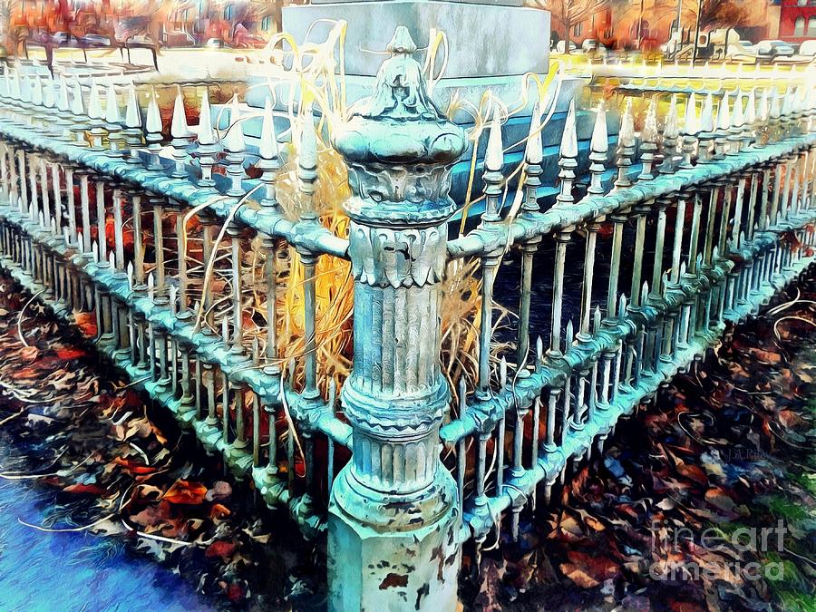 decorative wrought iron fence with intricate details and autumn leaves surrounding it