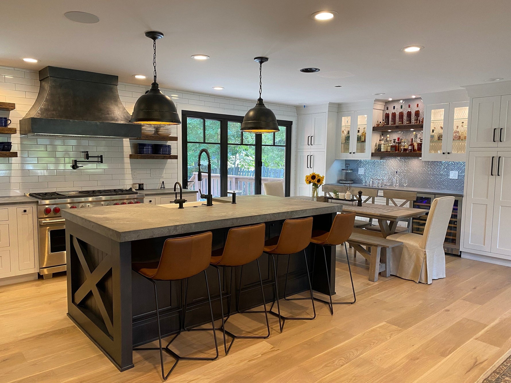 modern kitchen redesign featuring a custom range hood and stylish bar seating