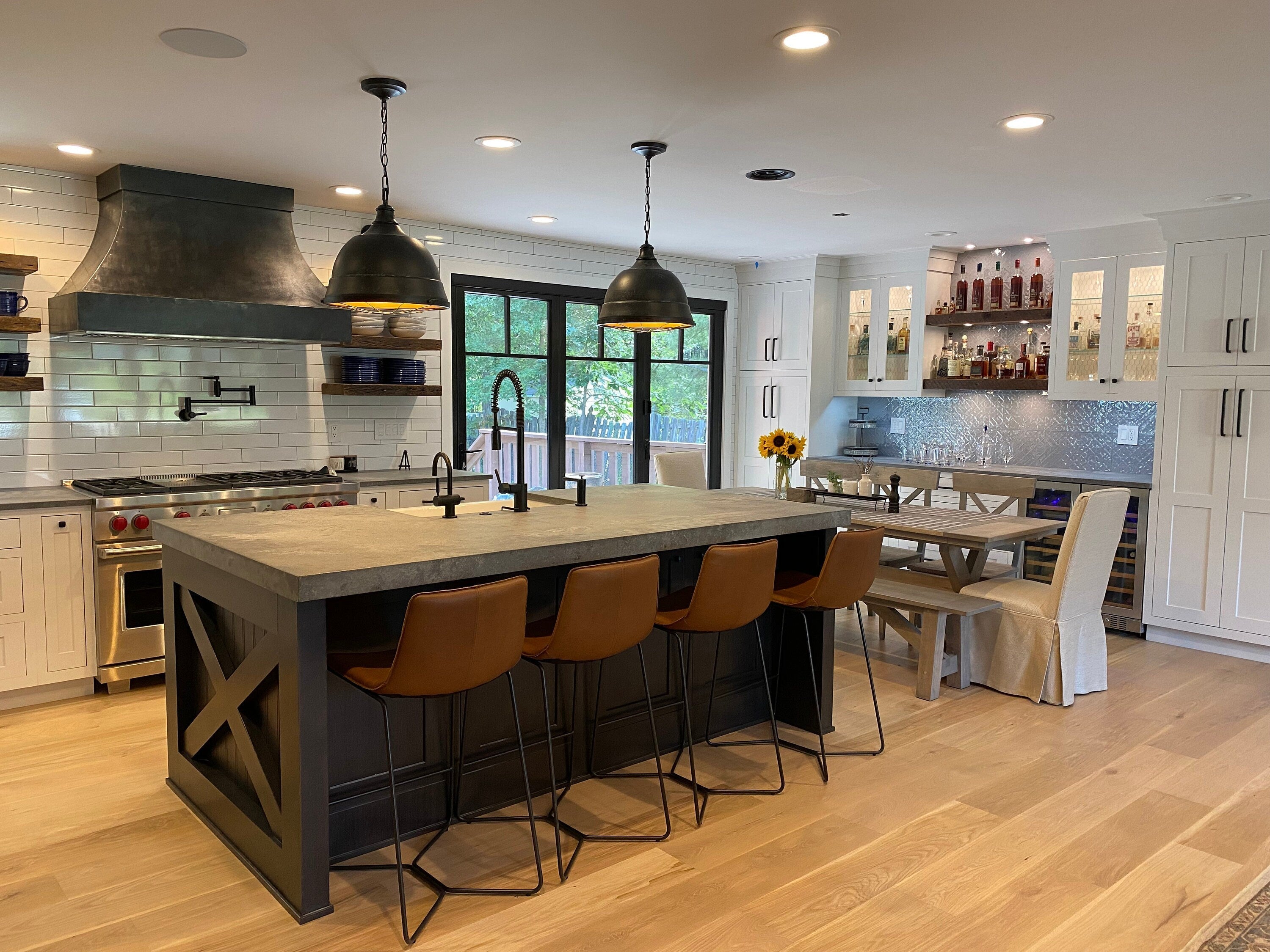 modern kitchen redesign featuring a custom range hood and stylish bar seating