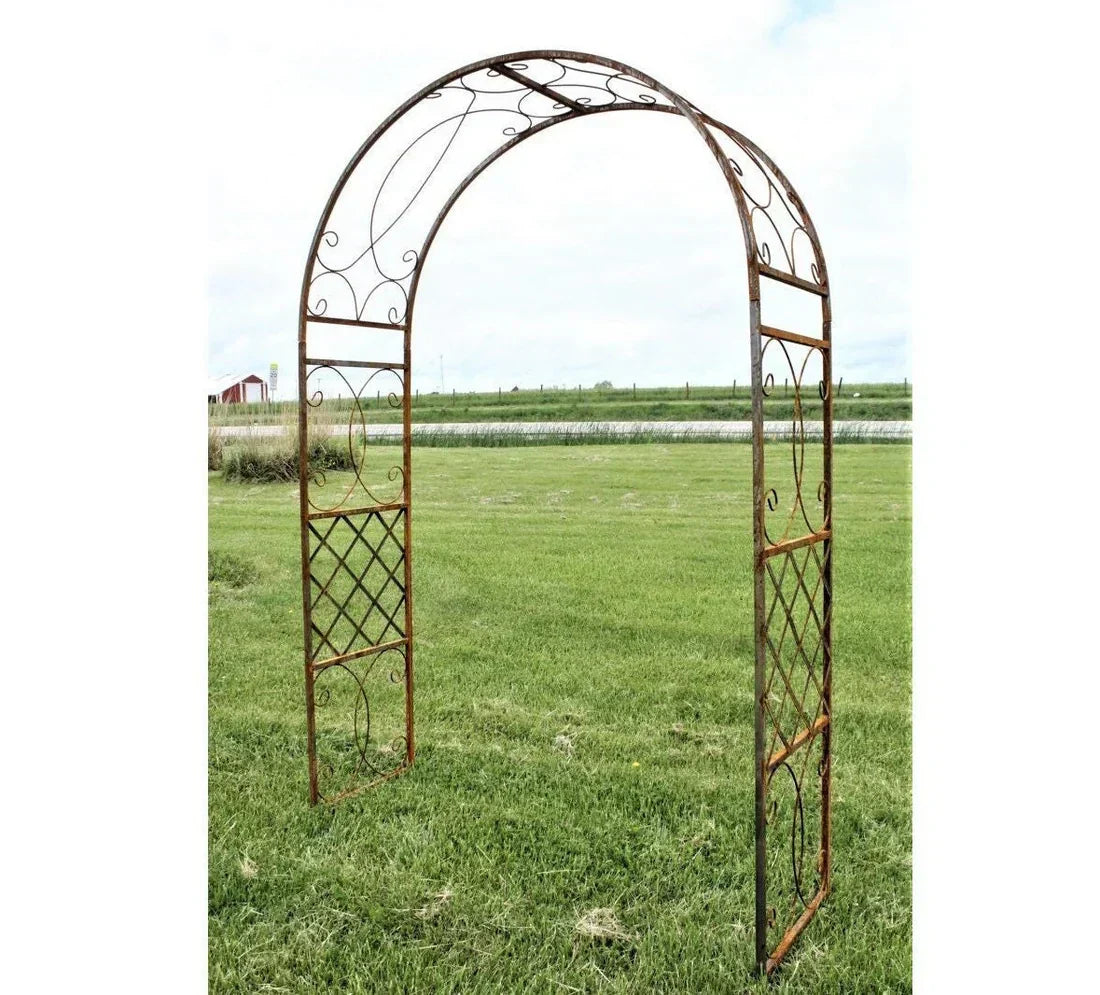 Rustic iron wedding arch with intricate designs, perfect for outdoor ceremonies