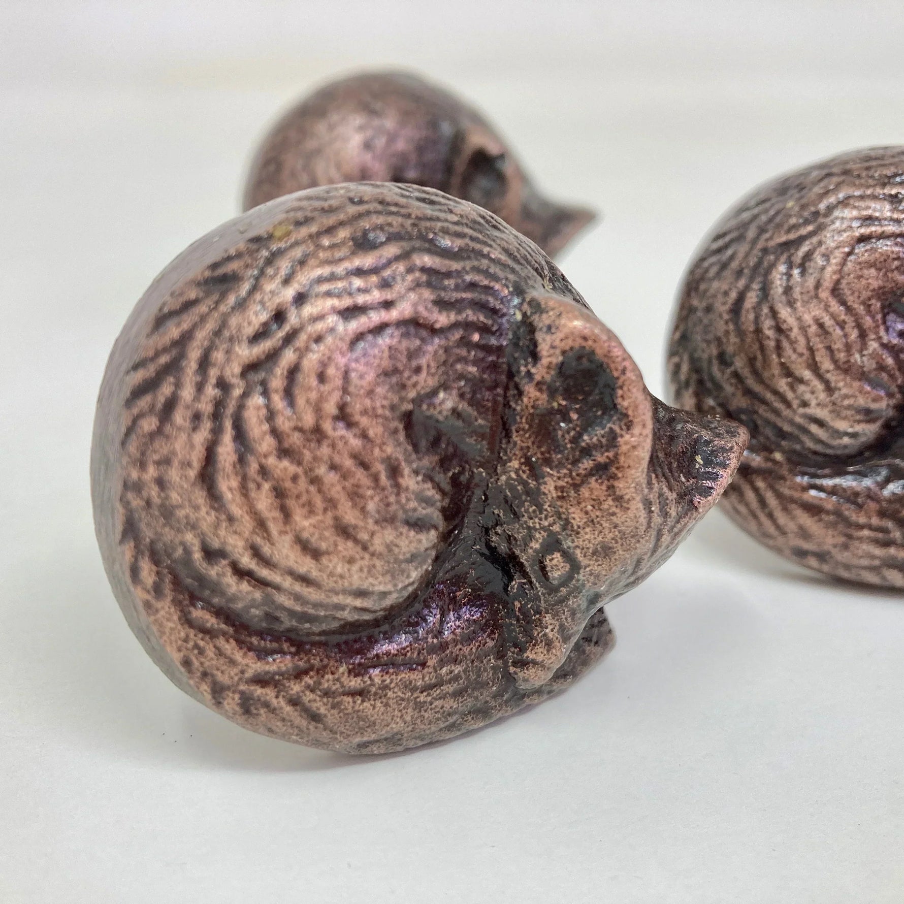 Decorative bronze dresser drawer knobs shaped like curled up mice for stylish furniture accents
