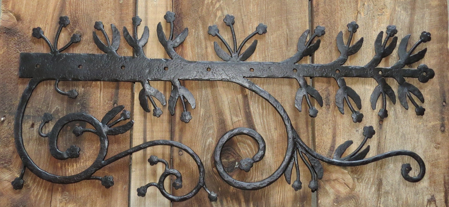 Ornate black hinge strap with floral design, perfect for enhancing door aesthetics