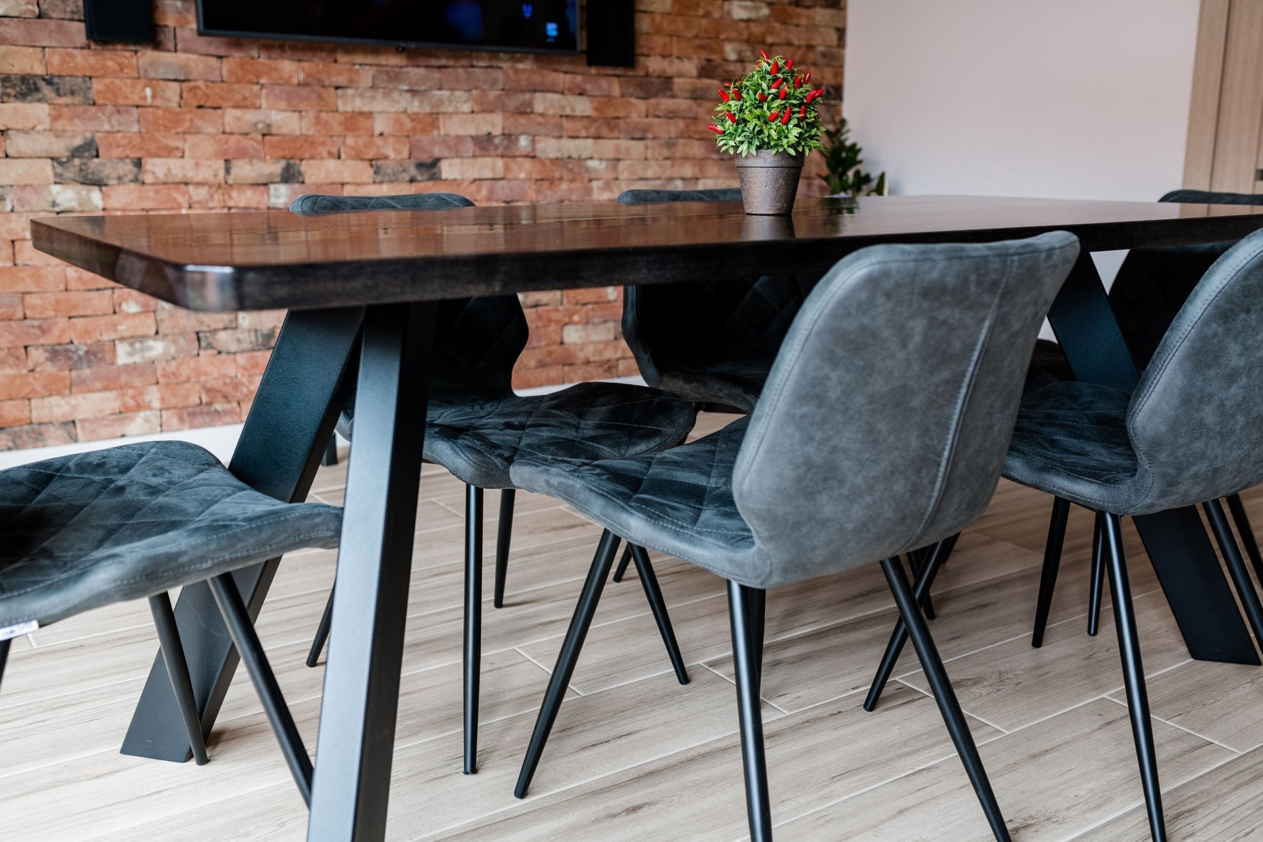 Modern dining table with metal legs and upholstered chairs in elegant setting