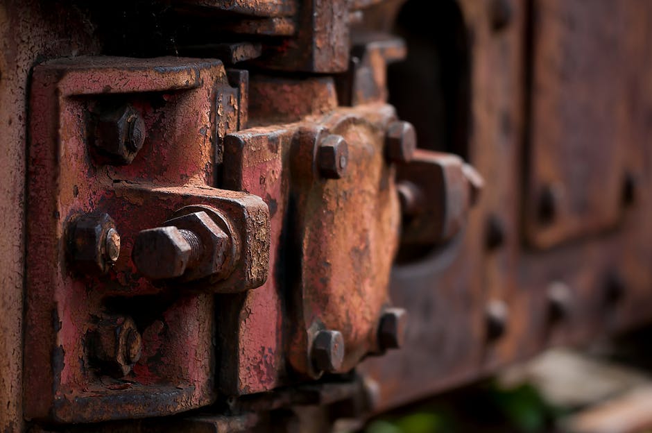 Close-up of weathered metal bolts on rustic machinery display for home decor inspiration