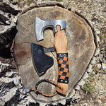 Axes with checkered handle on a wooden stump