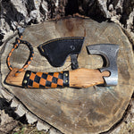 Axes with leather handles on a wooden stump