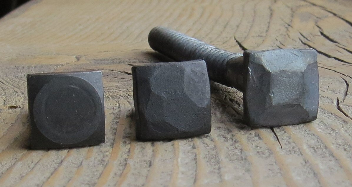 A look at 3 different textured square head bolts Smooth, Hammered, and Pyramid all are painted black on a wood background.