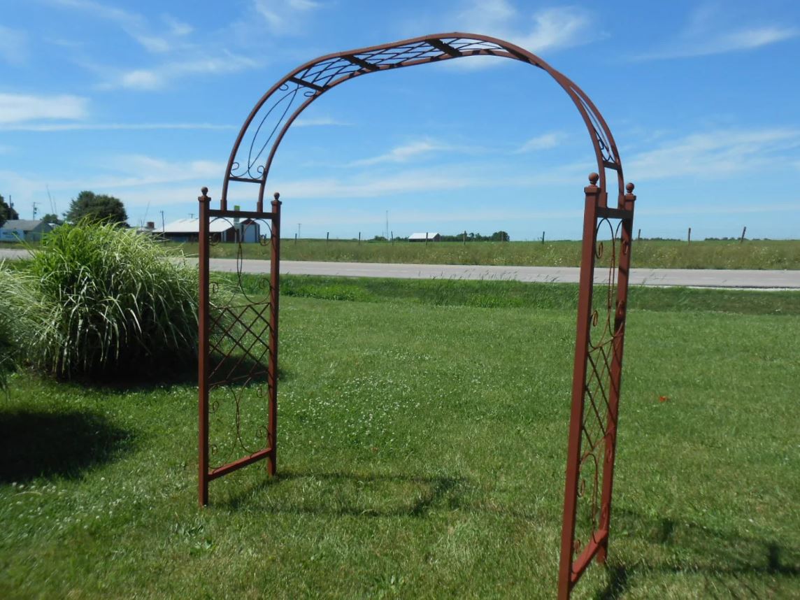 Rustic iron arbor design, ideal for outdoor spaces and enhancing natural surroundings