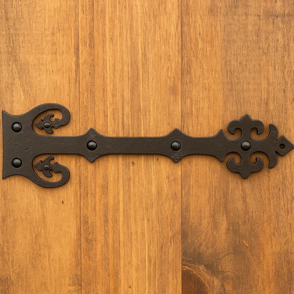 Decorative black metal hinge on a wooden surface