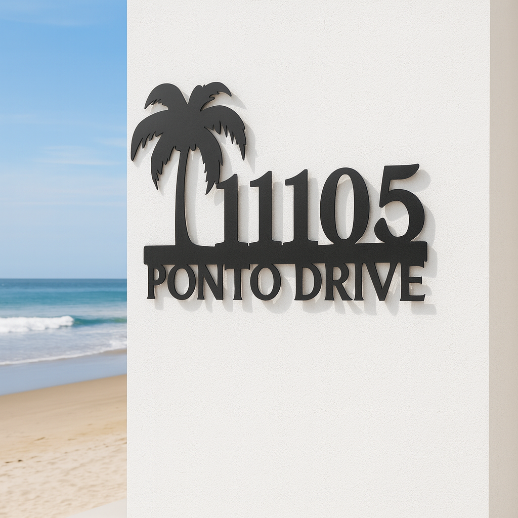 Black metal address sign with palm trees on a white background, beach visible in the corner.