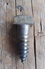 A side view of a 5/8" square head lag screw with a smooth texture and a raw finish on a wood background.