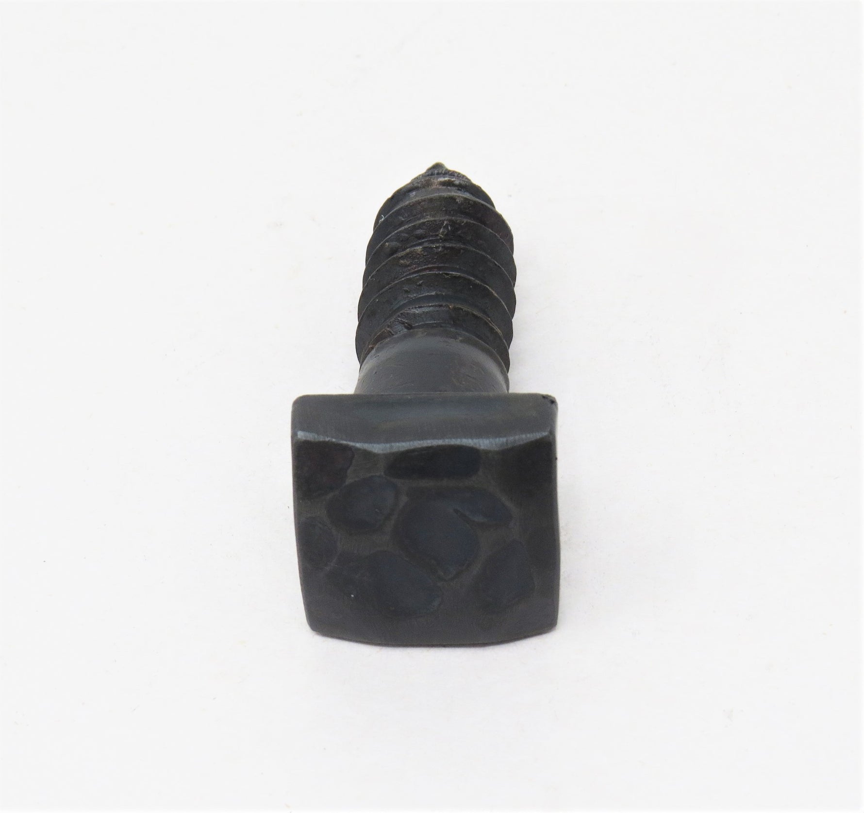 a side view of a hand hammered square head lag with a gun metal finish  with a white background