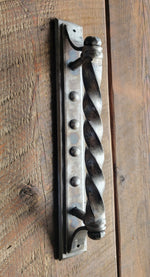 Decorative metal door handle on a wooden door